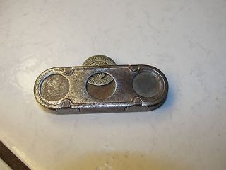 The J.E. Mergott Co token holder, metal, spring activated, Duluth 