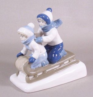   Mexico Porcelain Figurine Girl & Boy on Snow Sled Blue Brown White