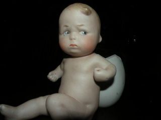   HEUBACH BISQUE CHARACTER MOVING PIANO BABY W/ EGG TOOTHPICK HOLDER