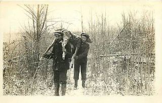 REAL PHOTO TWO MEN CARRYING DEAD DEER IN SNOW HUNTING M​AILED 1914 