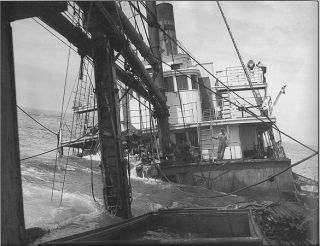 The sinking of the lumber schooner RIVERSIDE on Blunts Reef in 1913.