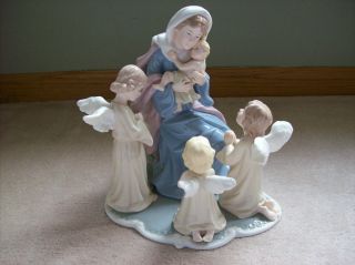   Treasures Porcelain  Mary With Baby Jesus And Angels Table Figurine