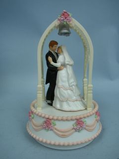   stock 555800 bride and groom in arbor musical cake topper by enesco