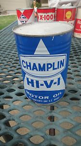 CHAMPLIN HI V I metal oil can used at gas station by visible gas pump 