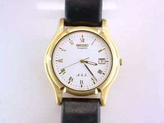  quartz watch runs gold tone b ezel case black leather band crystal in