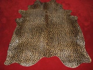 Leopard Print Cowhide Rug on Caramel Background