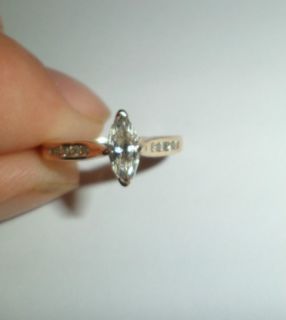 Beautiful Marquise diamond engagement ring with accents on the band