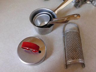 Vintage old metal red handle biscuit cutter, measuring cups, nutmeg