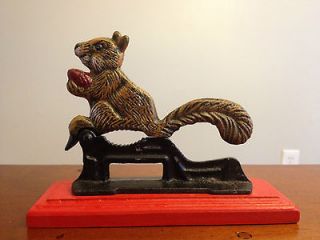 Cast iron squirrel nutcracker on red wooden base~very heavy~7.5L x 5
