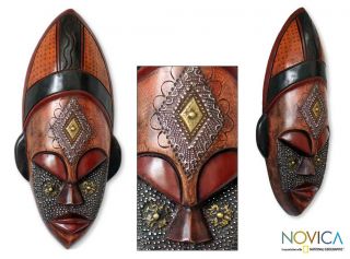 Sese Wood Dan Beauty African Mask (ghana) (Brown, orangeMaterials Sese wood, brass, aluminumDecorativeDimensions 16.1 inches high x 7.9 inches width x 3.2 inches deepStory Behind the ArtAs an artist, Rita Addo Zakour proudly includes African themes int