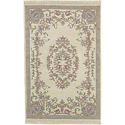 Hand knotted Aubusson Wool Rug (26 X 12) (IvoryPattern OrientalMeasures 0.625 inch thickTip We recommend the use of a non skid pad to keep the rug in place on smooth surfaces.All rug sizes are approximate. Due to the difference of monitor colors, some r